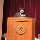 Fuentes speaking on stage