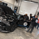 students looking at Shelby car